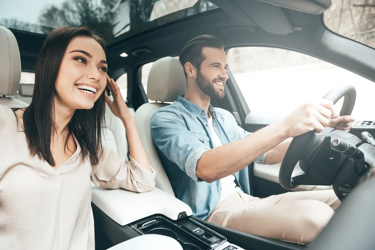 A man and a woman driving in a car